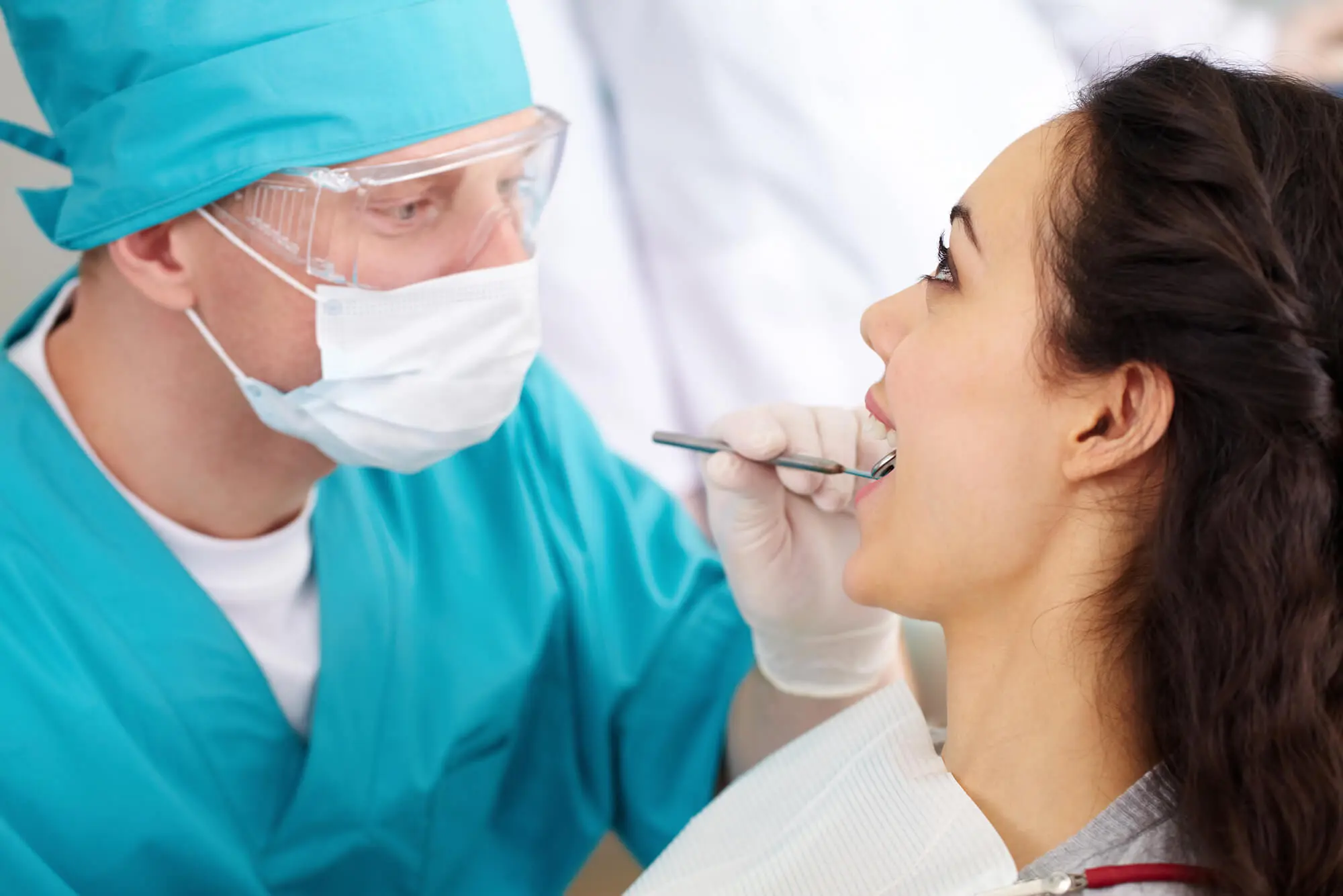 The dentist examines the girl