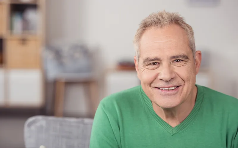 Smiling man in a green sweater