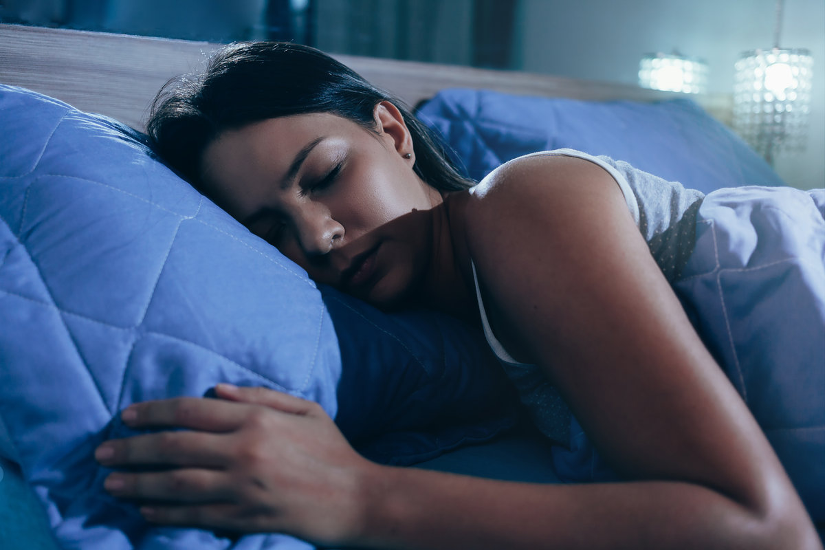 Woman lying in her bed sleeping comfortably
