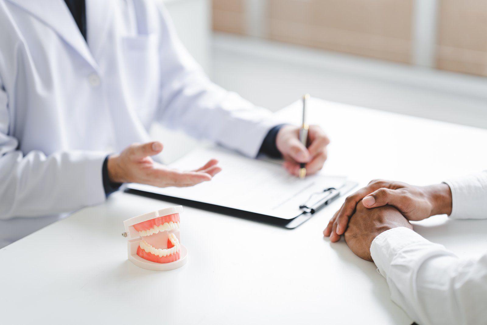 Dentist explaining full mouth reconstruction treatment options to a patient